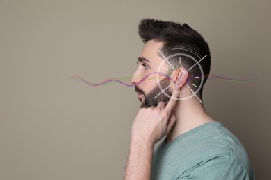 Image of Hearing loss concept. Handsome man and sound waves illustration on beige background, closeup