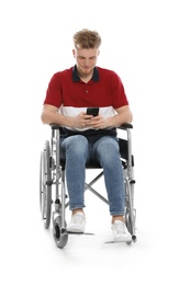 Young man in wheelchair using mobile phone isolated on white