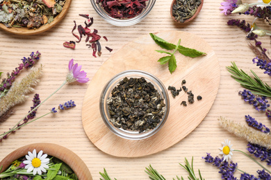 Flat lay composition with healing herbs on wooden table