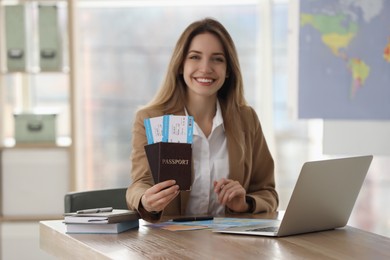 Photo of Travel agent with tickets and passports in office