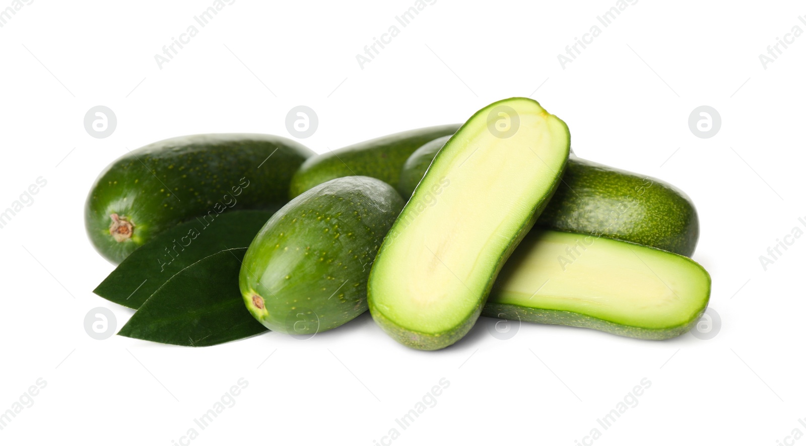 Photo of Cut and whole seedless avocados with leaves isolated on white