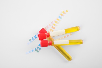 Photo of Test tubes with urine samples for analysis on white background, top view