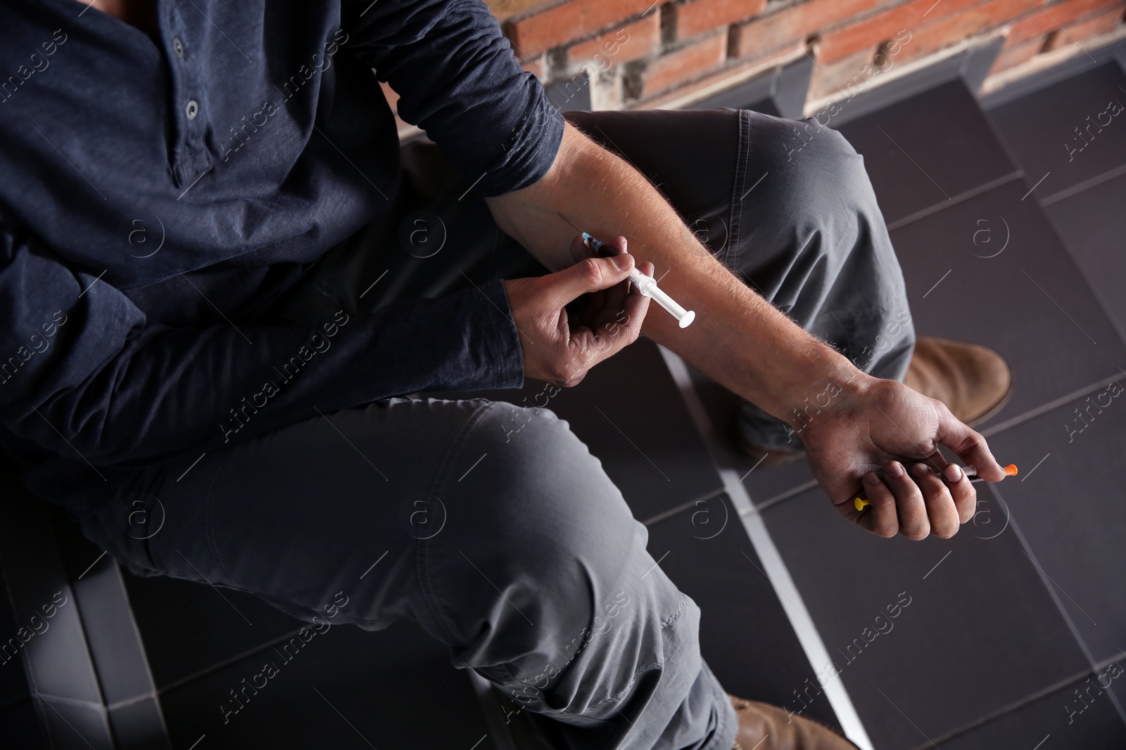 Photo of Male drug addict making injection, closeup of hands