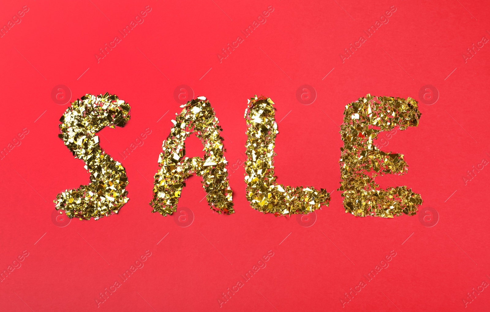 Photo of Word sale made of golden metallic confetti on red background, flat lay. Black Friday