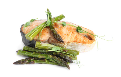 Tasty salmon steak with asparagus isolated on white