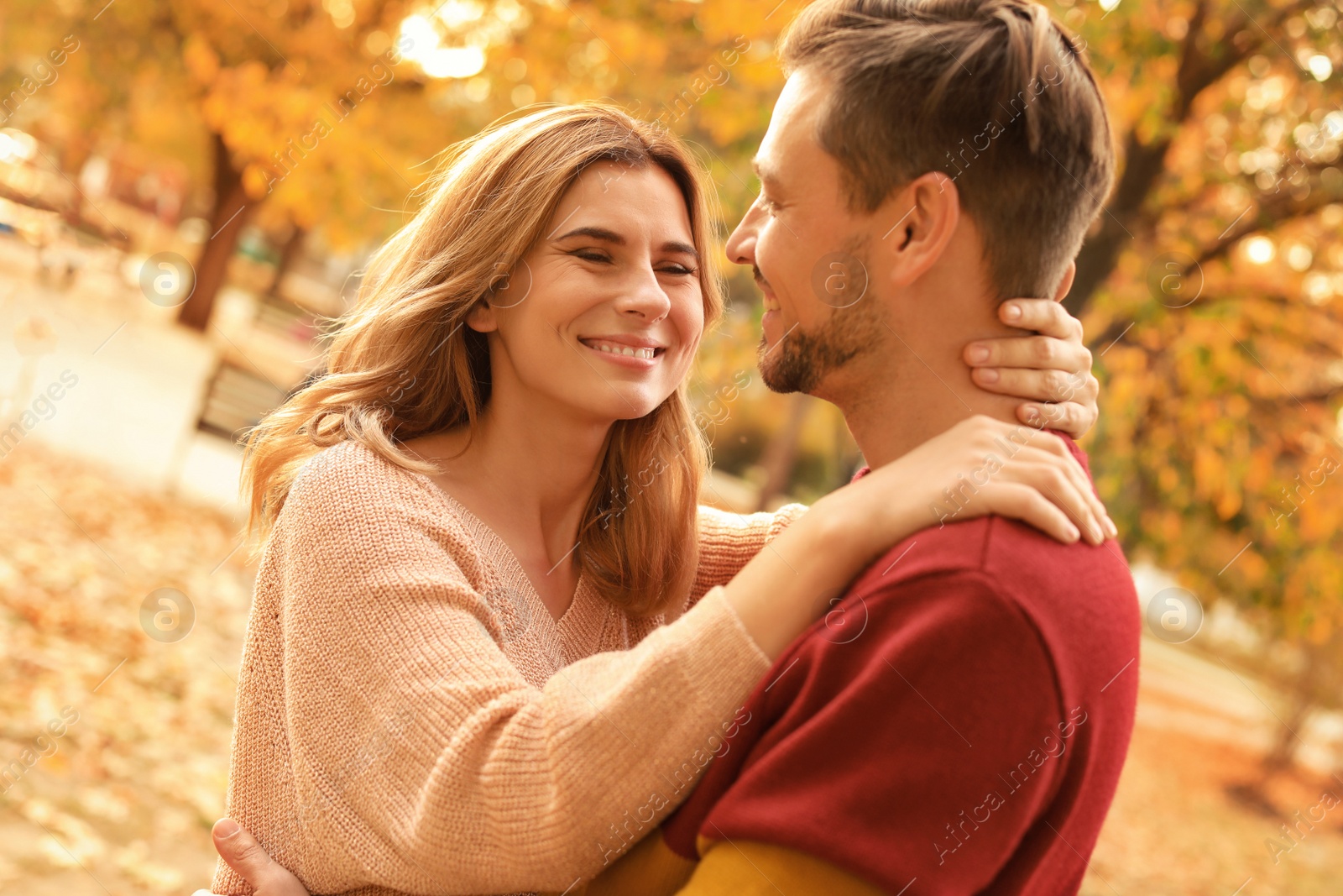 Photo of Lovely couple spending time together in park. Autumn walk