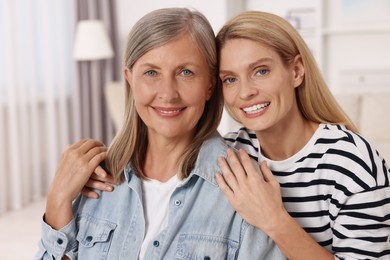 Photo of Happy mature mother and her daughter at home