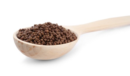 Photo of Wooden spoon with buckwheat tea granules on white background