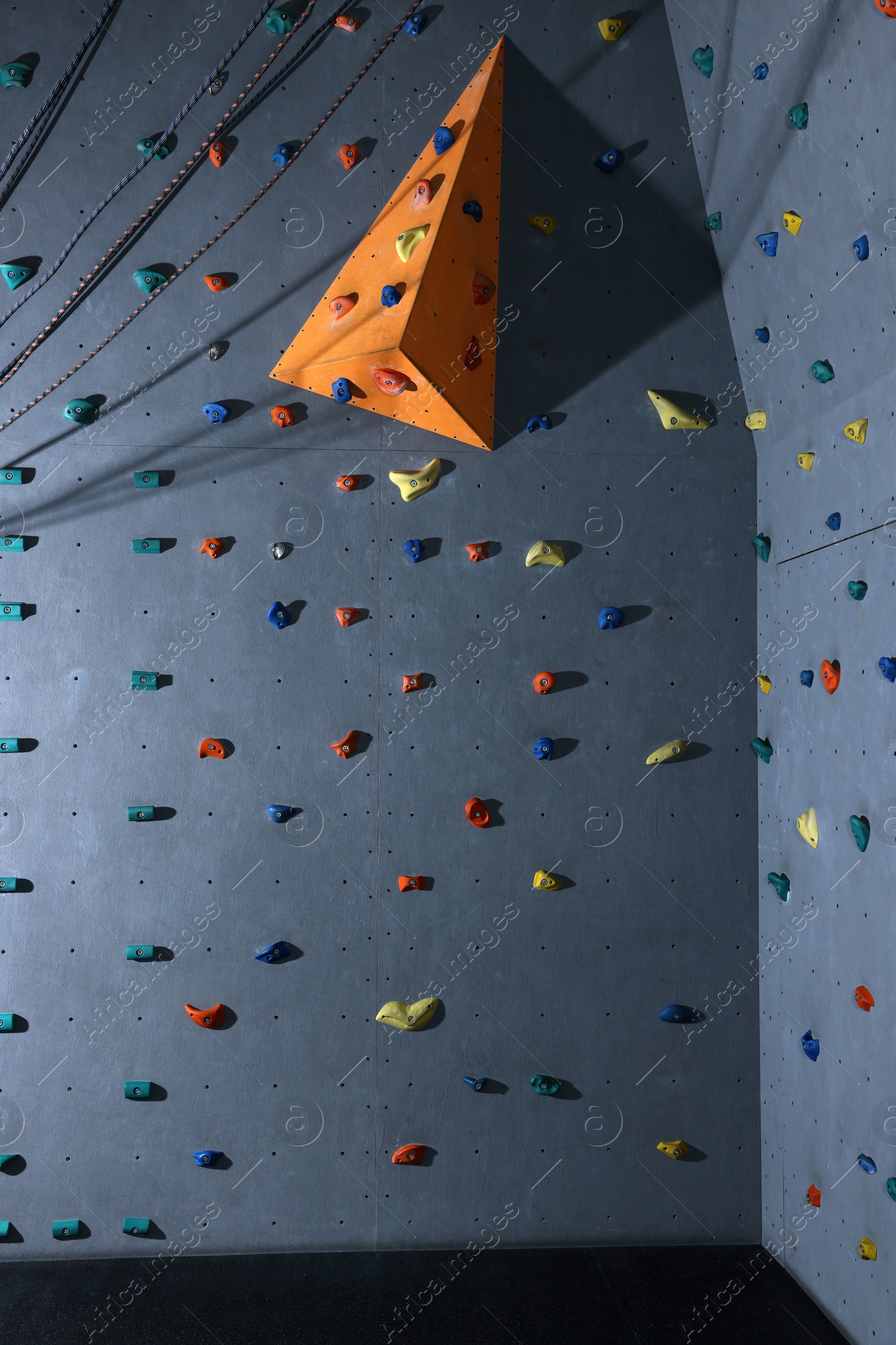 Photo of Climbing wall with holds in gym. Extreme sport