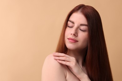 Portrait of beautiful woman on beige background. Space for text