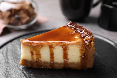 Piece of delicious cake with caramel served on plate, closeup