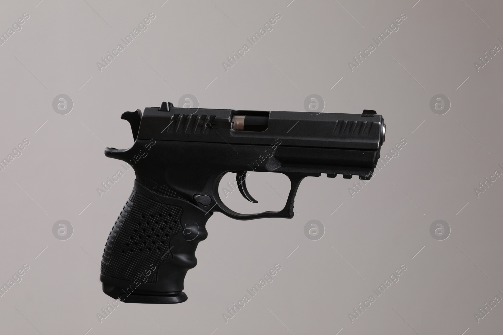 Photo of Standard handgun on light grey background. Semi-automatic pistol