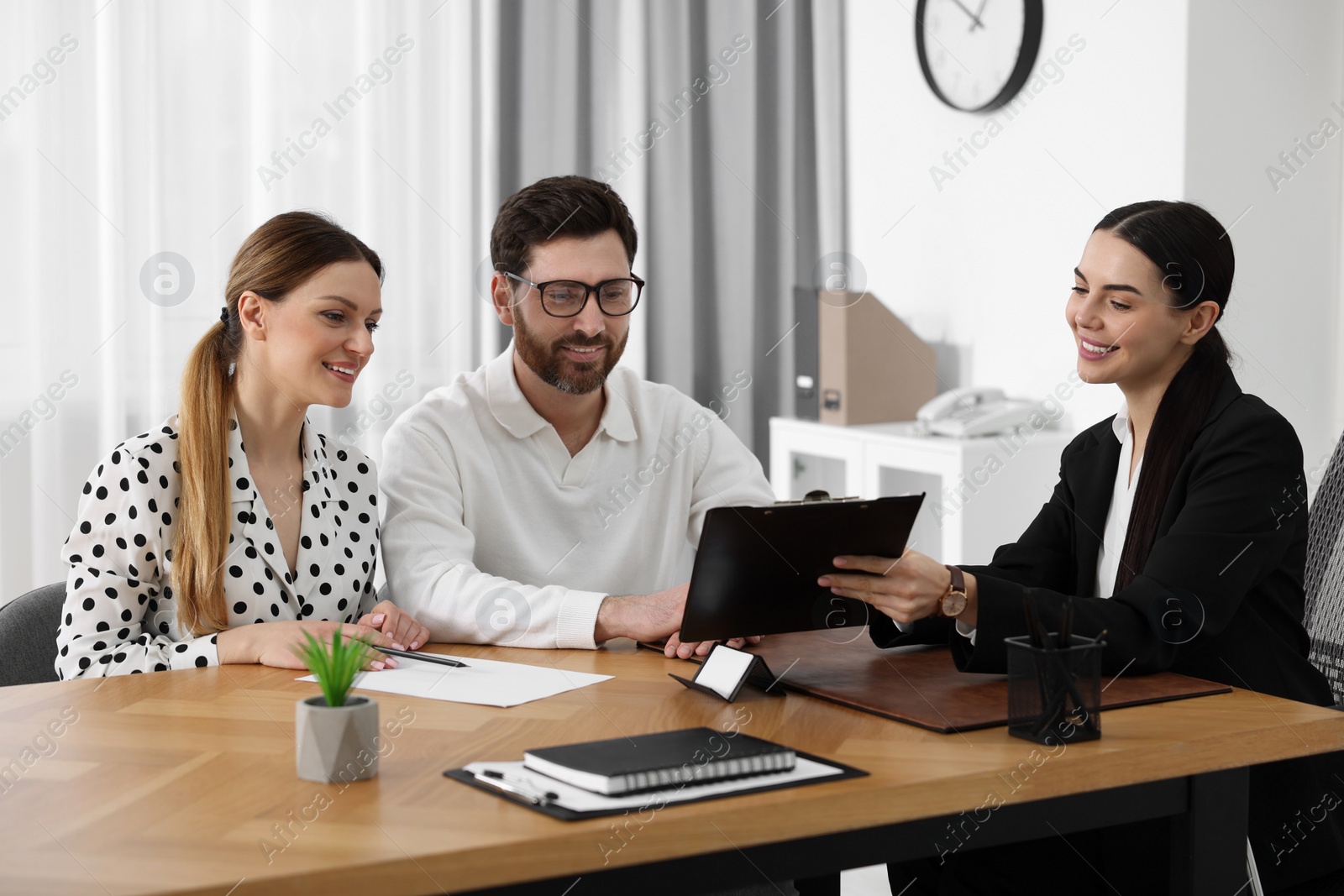 Photo of Couple having meeting with lawyer in office