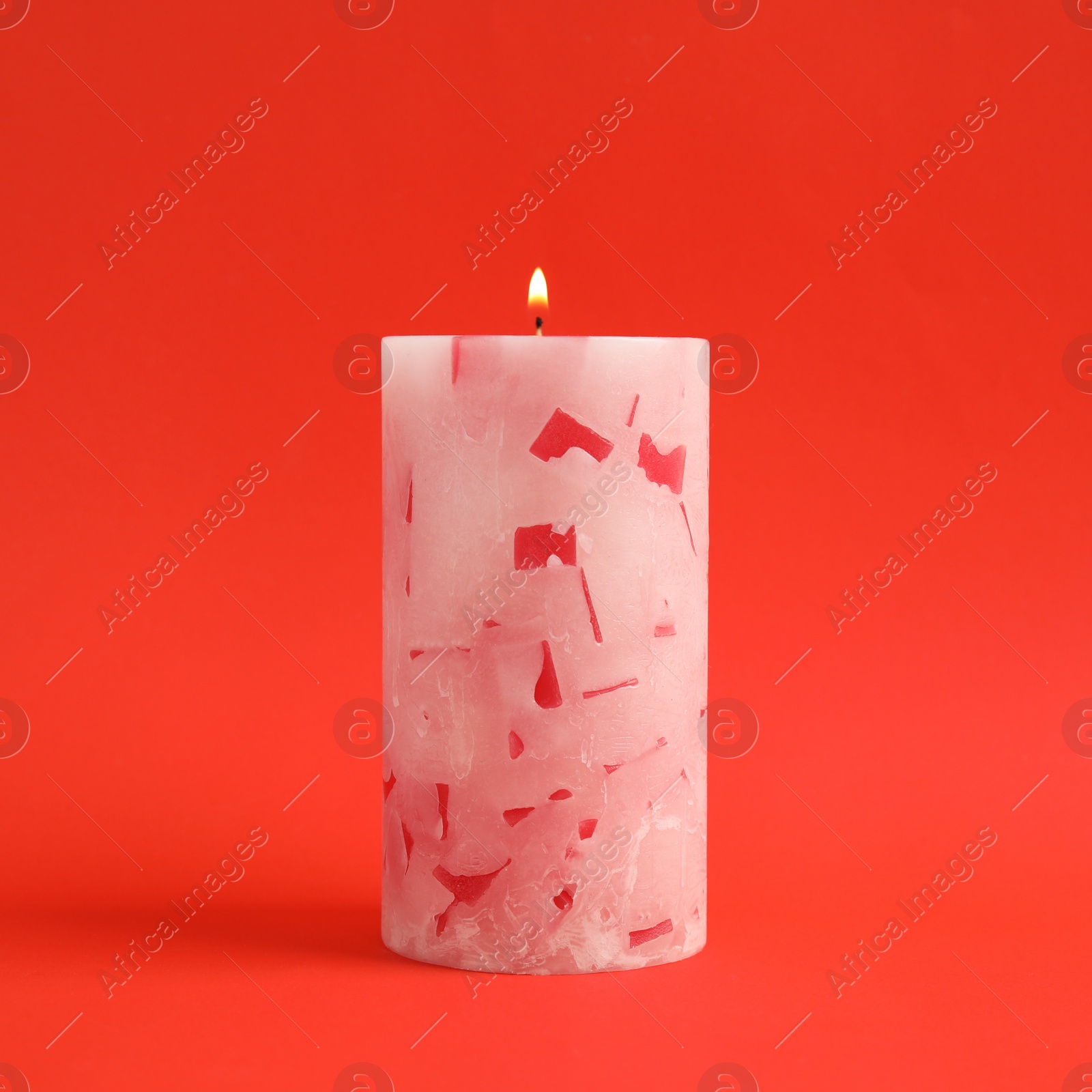 Photo of Alight scented wax candle on color background