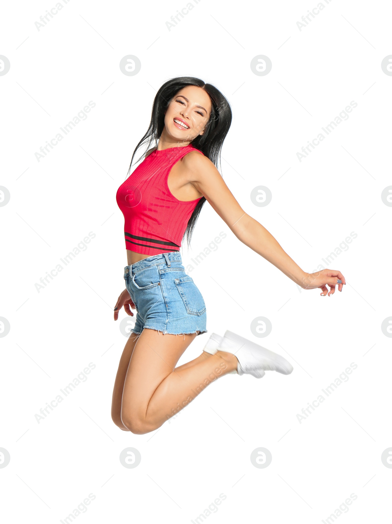 Photo of Beautiful happy woman jumping on white background