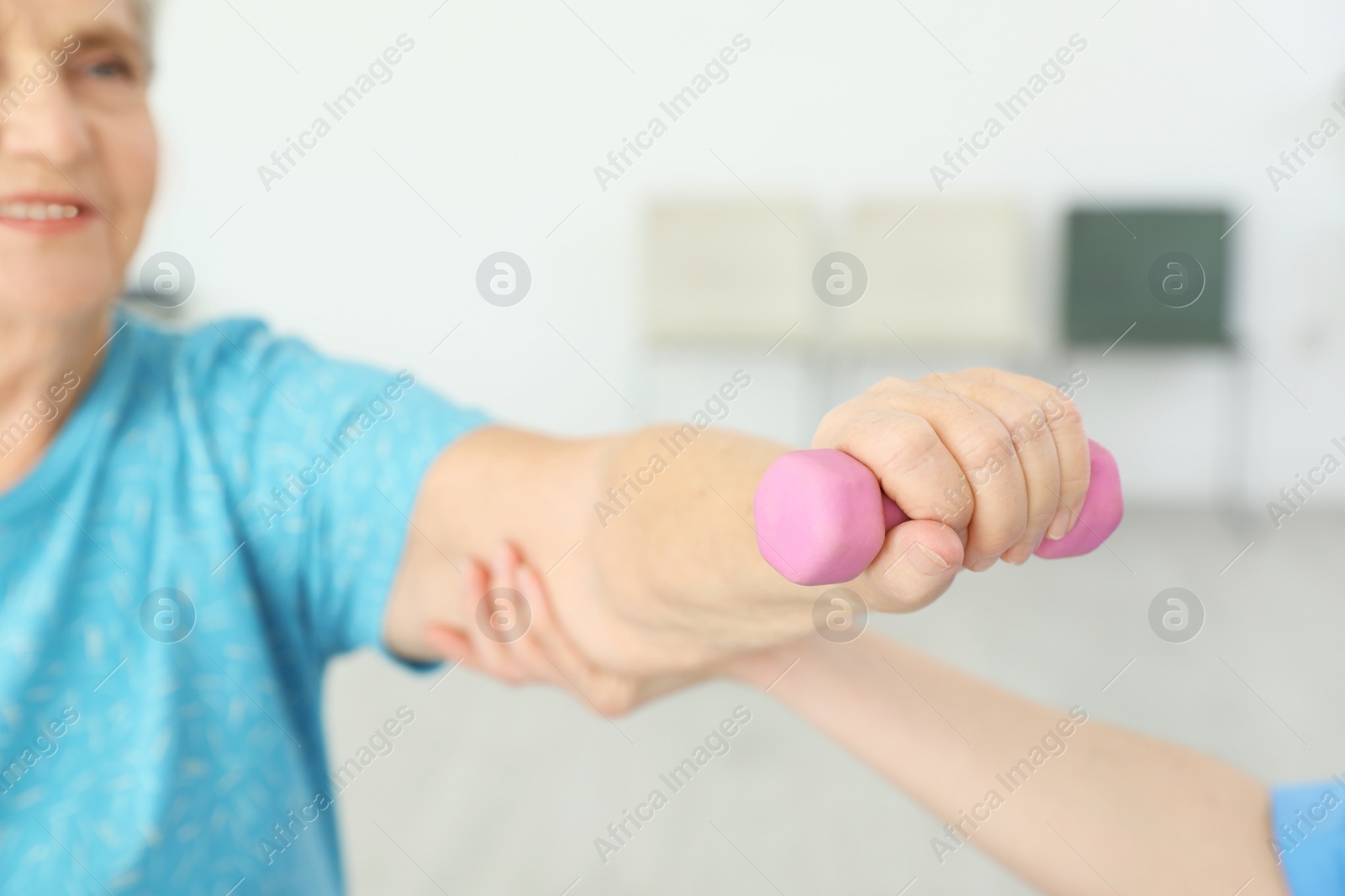 Photo of Professional physiotherapist working with elderly patient in rehabilitation center, closeup