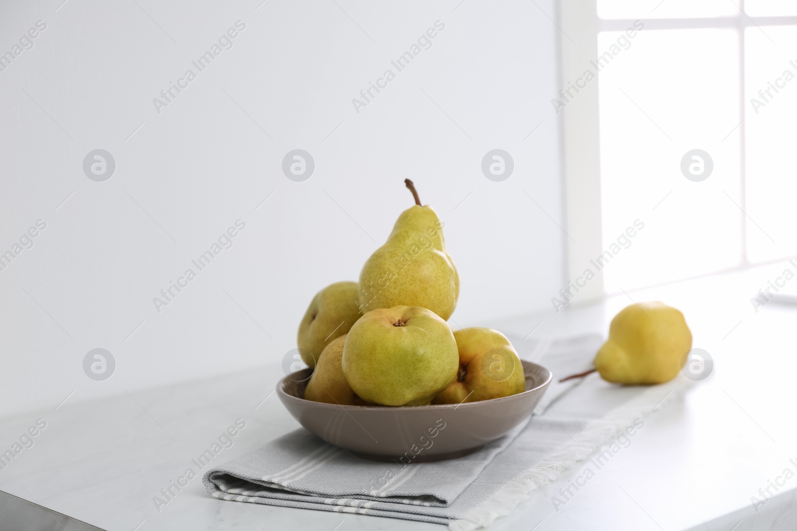 Photo of Fresh ripe pears on countertop in kitchen
