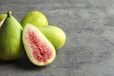 Fresh ripe figs on gray background. Space for text