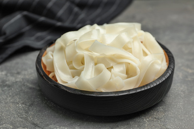 Tasty cooked rice noodles on grey table, closeup