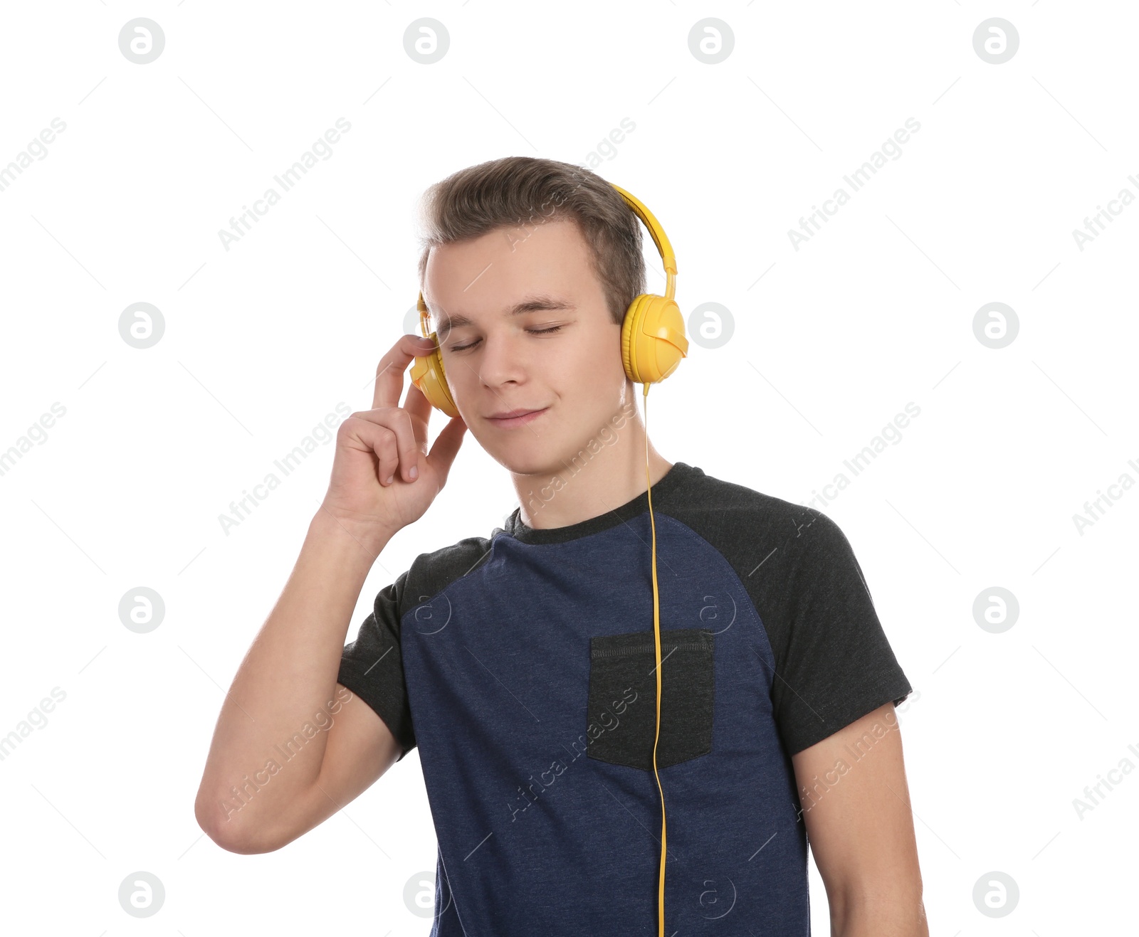 Photo of Teen boy listening to music with headphones on white background