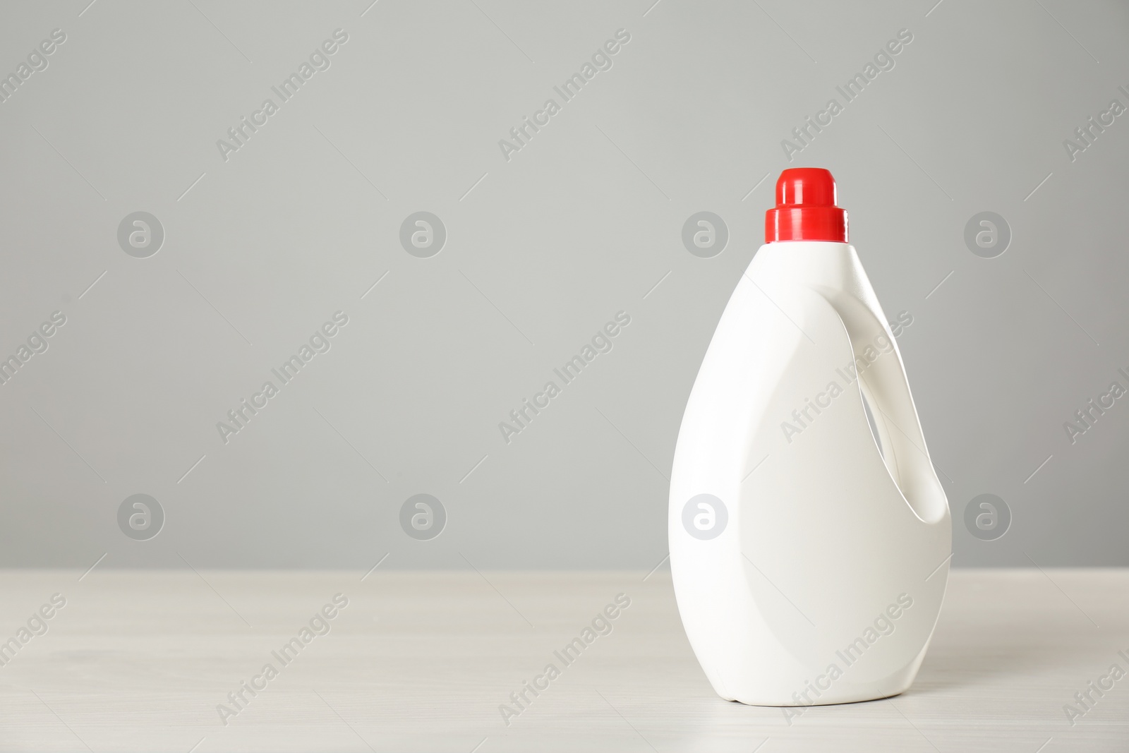 Photo of Bottle of cleaning product on light table. Space for text