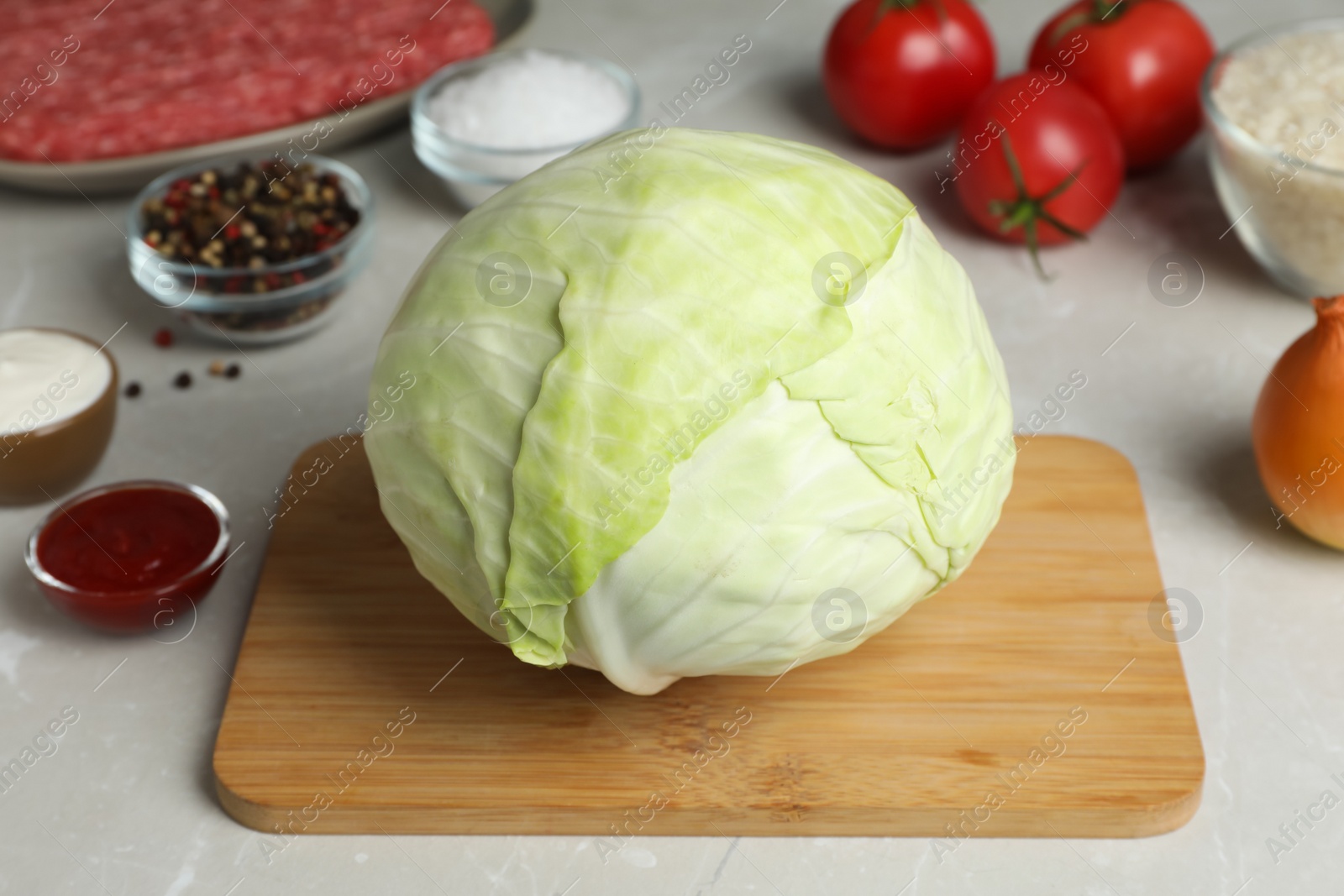 Photo of Set of ingredients for preparing stuffed cabbage rolls on light table