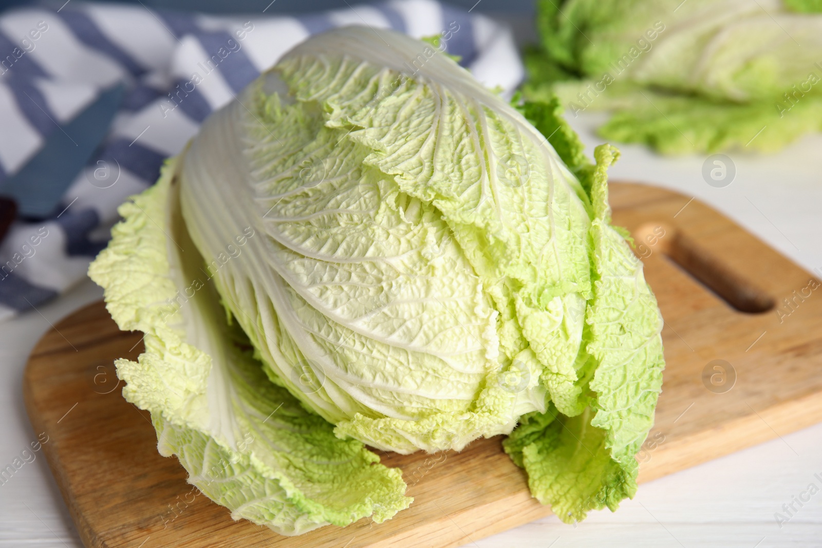 Photo of Fresh ripe Chinese cabbage on white wooden table, closeup
