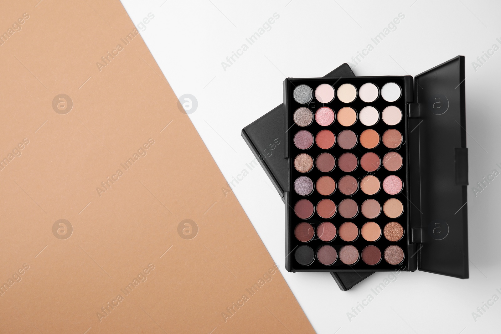 Photo of Eye shadow palette on colorful background, top view. Space for text