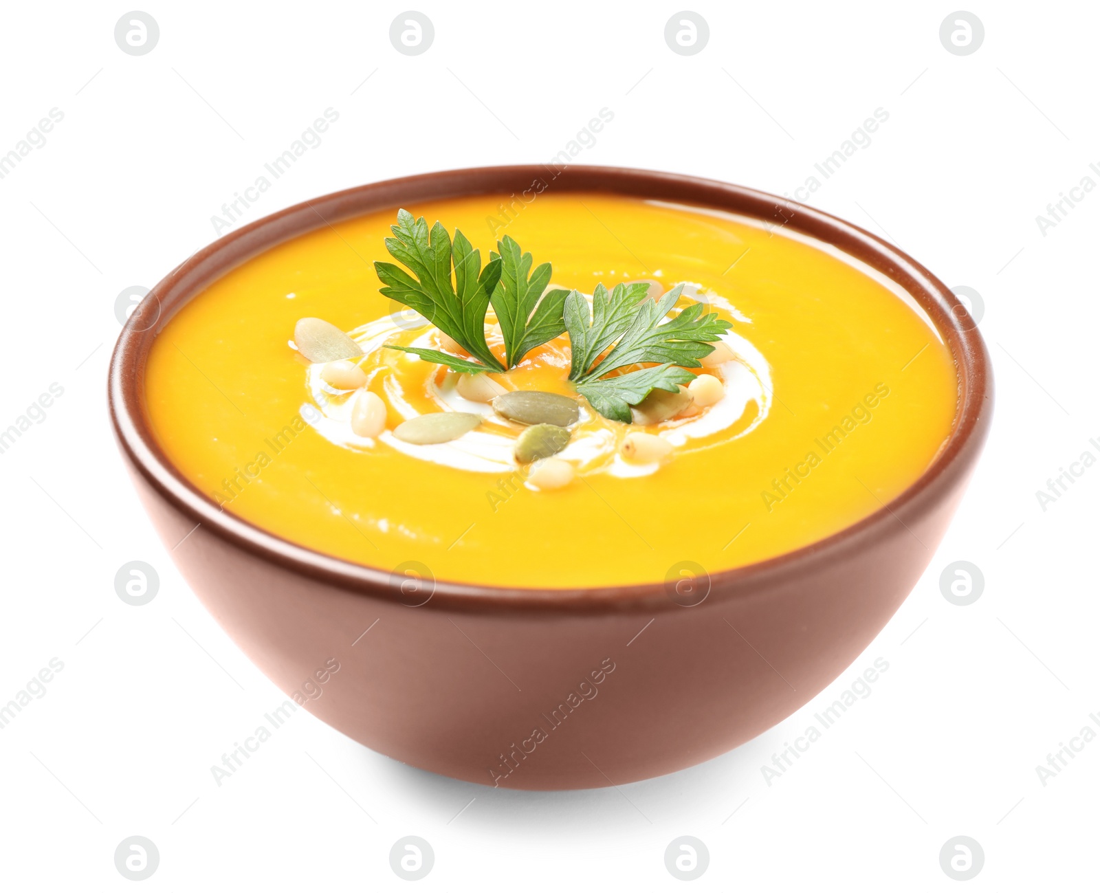 Image of Tasty creamy pumpkin soup in bowl on white background