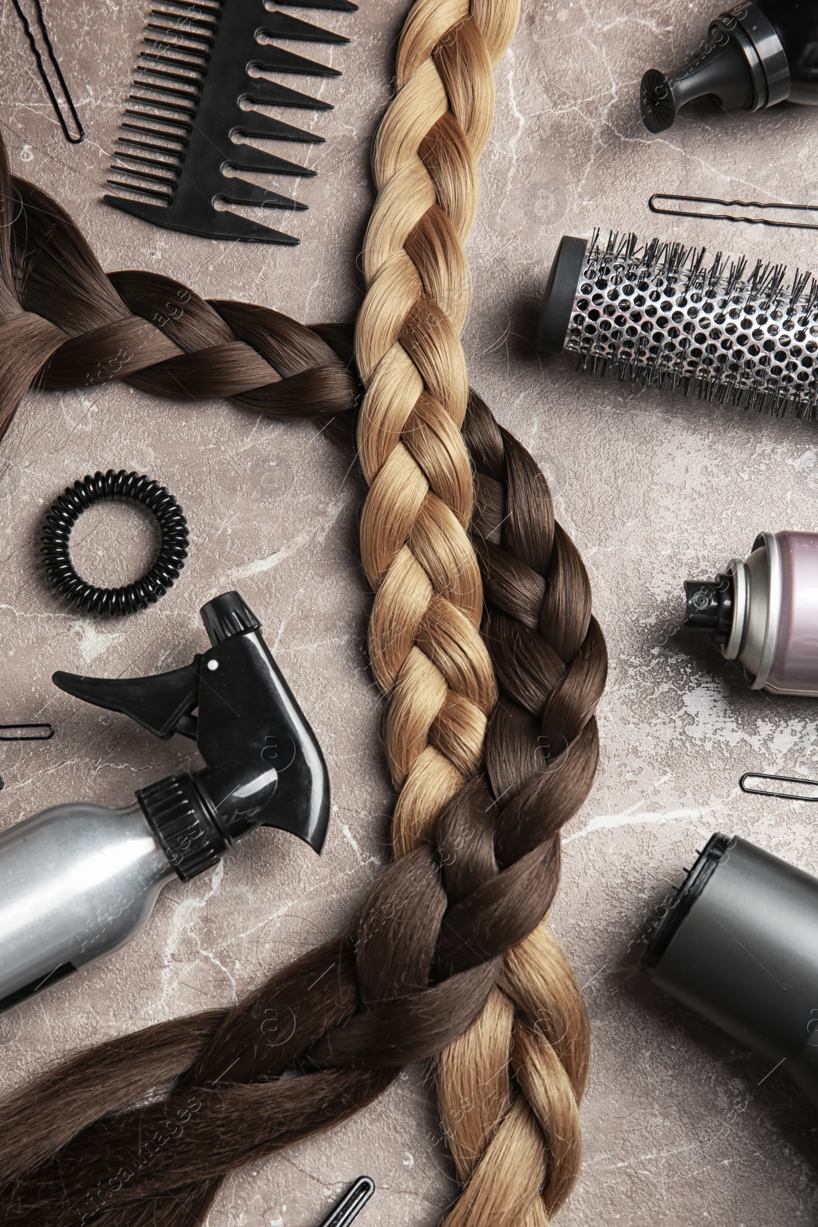 Photo of Flat lay composition with hair salon tools on grey background