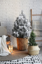 Stylish interior with beautiful Christmas tree near white brick wall