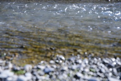 Blurred view of river coast on sunny day