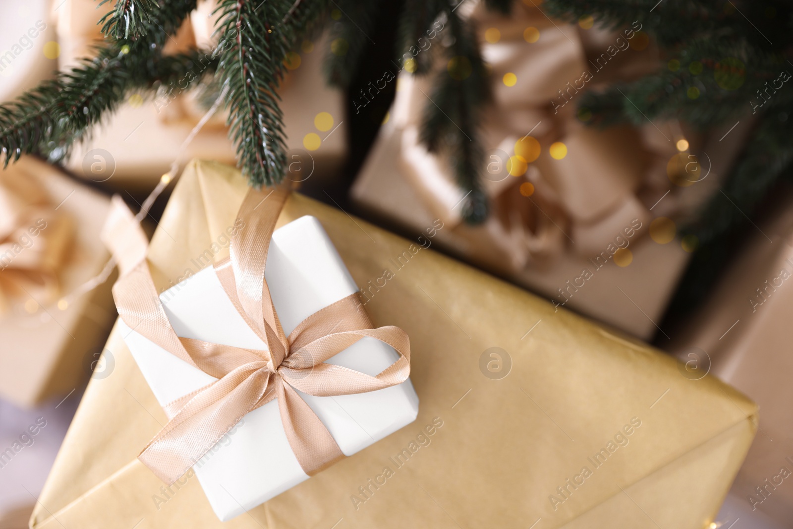 Photo of Beautiful gift boxes under Christmas tree, top view. Space for text