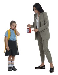 Photo of Teacher with alarm clock scolding pupil for being late against white background