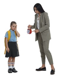 Teacher with alarm clock scolding pupil for being late against white background