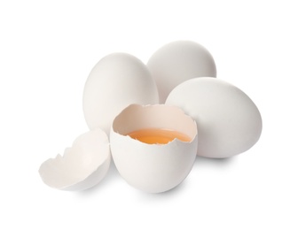 Photo of Cracked and whole chicken eggs on white background