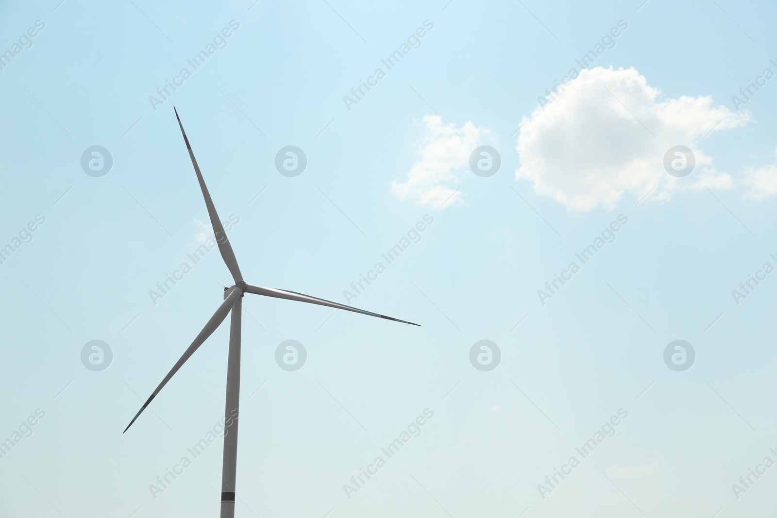 Photo of Modern wind turbine against blue sky, low angle view. Energy efficiency