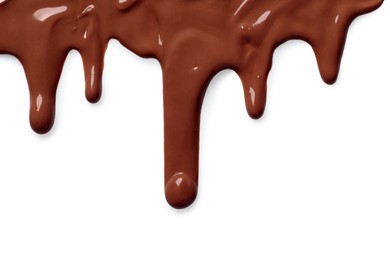 Photo of Tasty melted milk chocolate pouring down on white background