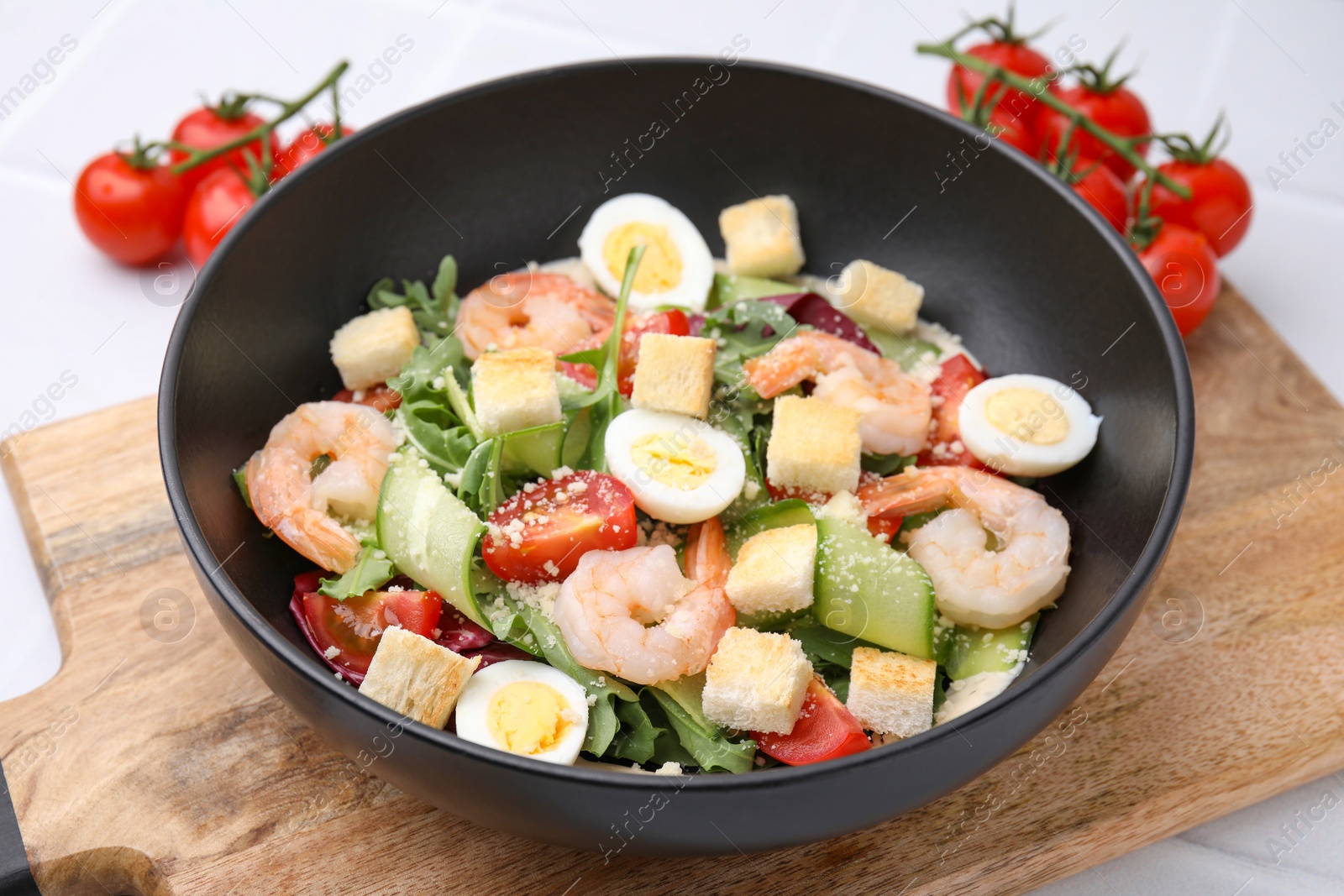 Photo of Delicious Caesar salad with shrimps on table, closeup