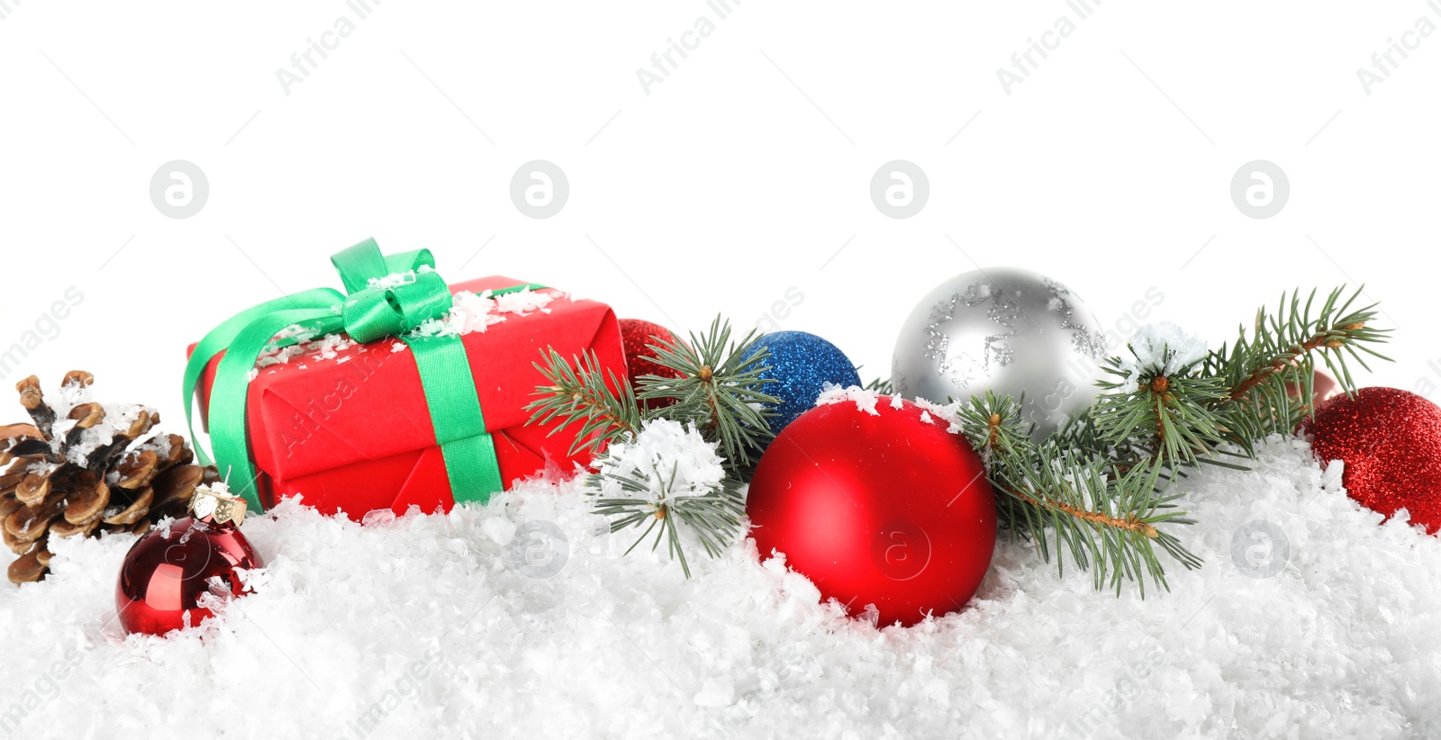 Photo of Christmas decoration with gift box on snow against white background