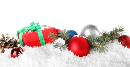 Christmas decoration with gift box on snow against white background