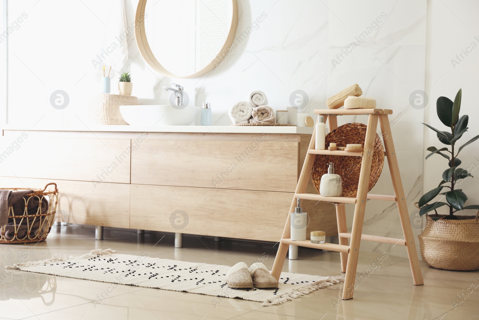 Photo of Dispensers and different toiletries on decorative ladder in bathroom. Idea for interior design