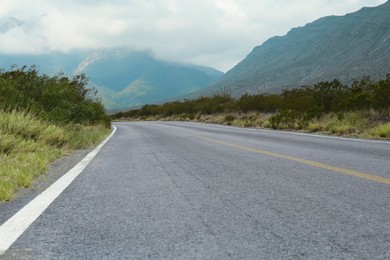 Empty asphalt road in mountains. Picturesque landscape