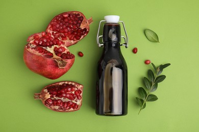 Photo of Flat lay composition with tasty pomegranate sauce and fruit on green table