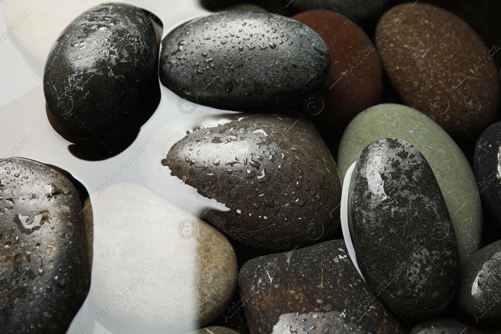 Photo of Pile of stones in water as background, closeup. Zen lifestyle