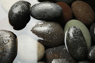 Photo of Pile of stones in water as background, closeup. Zen lifestyle