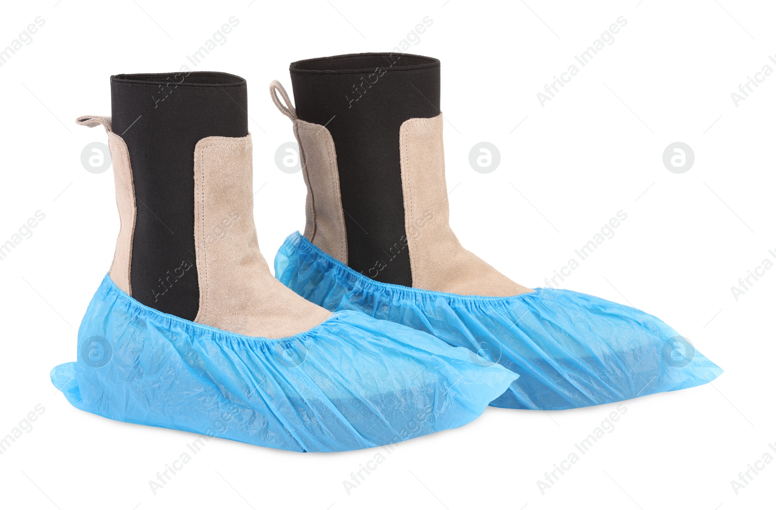 Photo of Women's boots in blue shoe covers isolated on white