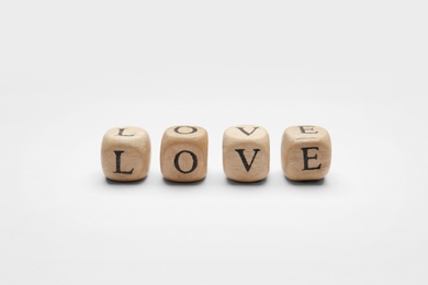 Mini cubes with letters forming word Love on white background