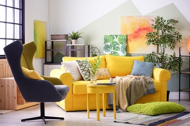 Photo of Stylish living room interior with comfortable sofa and armchair