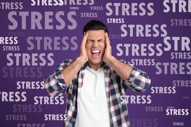 Stressed young man and text on violet background